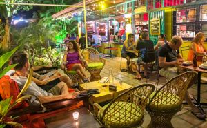 front patio at Café Milagro night scene with high energy patrons and colorful lights